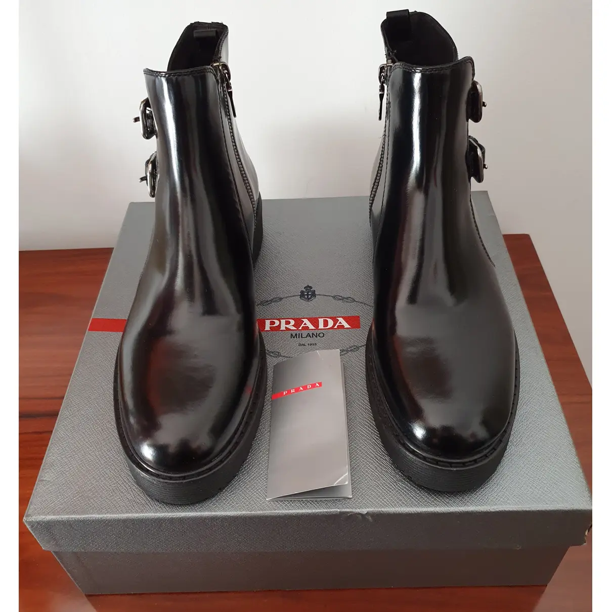 Patent leather buckled boots Prada