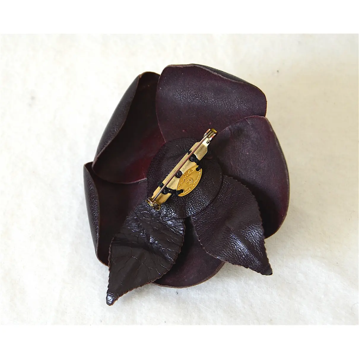 Buy Chanel Camélia leather pin & brooche online - Vintage