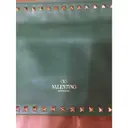 Buy Valentino Garavani Rockstud leather clutch bag online